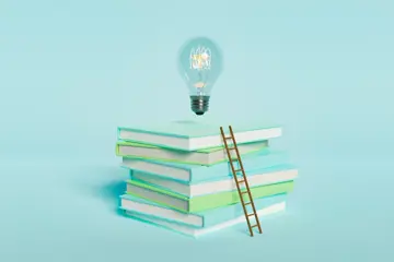 Books and ladder representing leadership learning and development