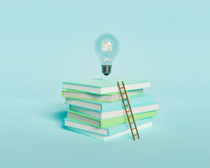 Books and ladder representing leadership learning and development