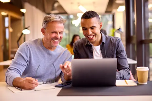 Professional mentoring and coaching a younger professional.