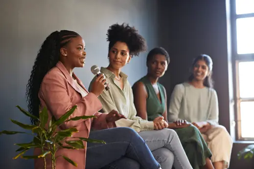 Group of 4 businesswomen engaged in a panel discussion